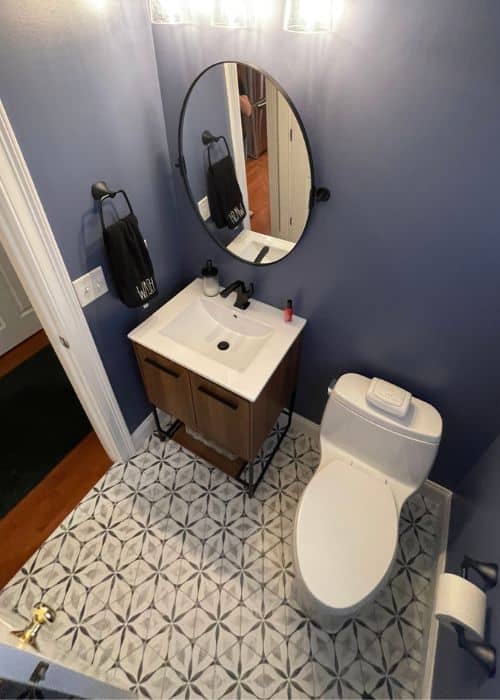 bold bathroom with modern floor tile and blue walls